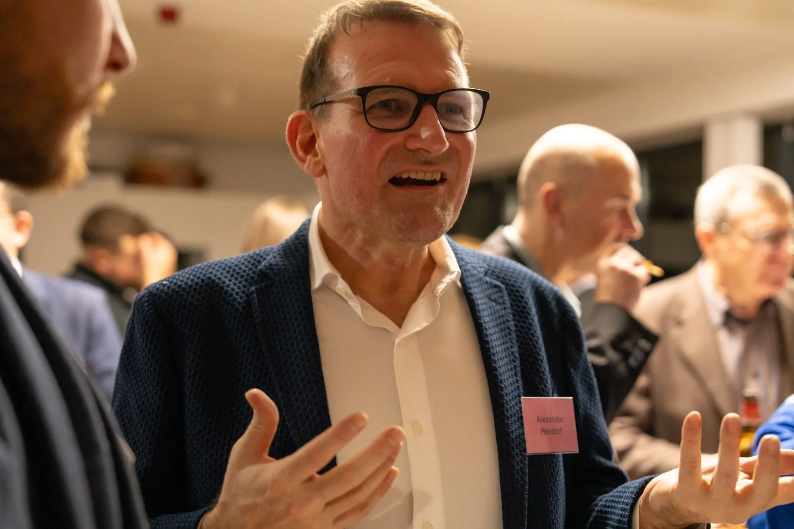 Alexander Hendorf in conversation while networking at a technology conference
